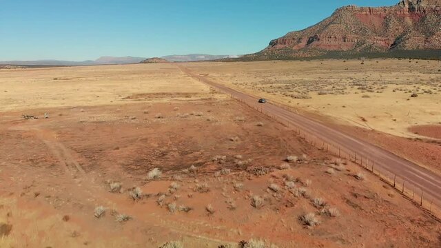 Slow Push in on Station Wagon with Bike Rack on Desert Road, Aerial