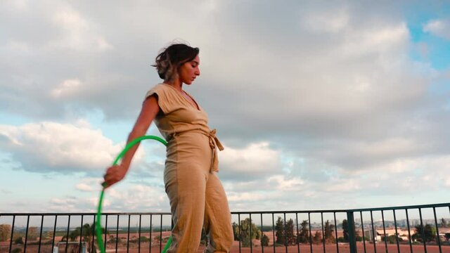 Surrealist visual effect based on shot of a flow artist moving with a Hula hoop, outdoors at sunrise.
