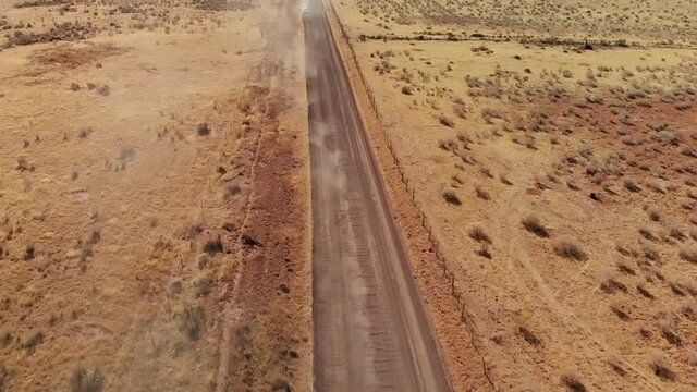 Dust Clouds Lead to Station Wagon on Open Desert Road, Aerial