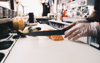 restaurant chef cutting salmon