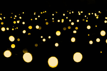 Obraz premium Bright Golden bokeh lights garland background. New year and Christmas. Abstract holiday background