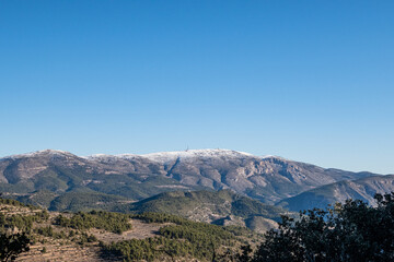 Fototapeta na wymiar Mount Aitana with snow, on a sunny winter day.