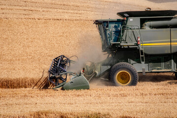 Close up of a combine in action harvesting a wheat field