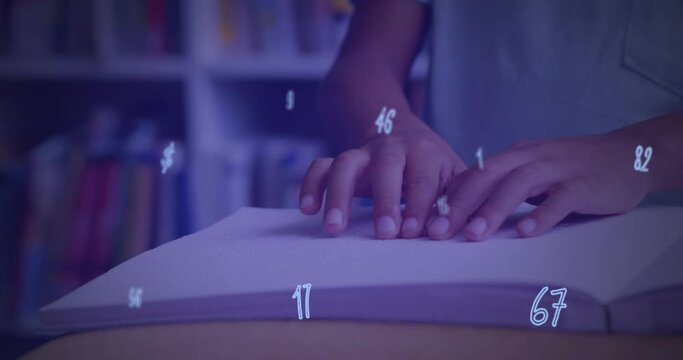 Digital composition of numbers and symbols floating against mid section of boy reading a book in bra