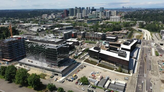 Cinematic drone footage of the new Spring District under construction in Bellevue, Washington downtown with residential and commercial skyscrapers along Interstate highway 405 in King County