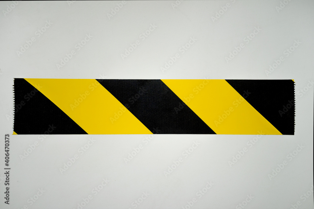 Wall mural black and yellow stripe from the warning tape on the white isolate