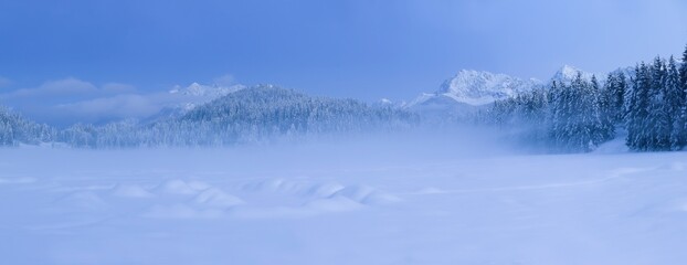 Bizarre, otherworldly winter landscape around frozen covered in ground fog