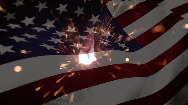 Animation of close up of sparklers against american flag waving