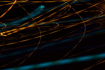 Luminous streamer - neon bright lines on black background.