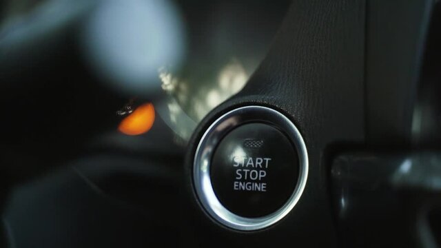 Woman presses engine start button in car. Button start stop engine