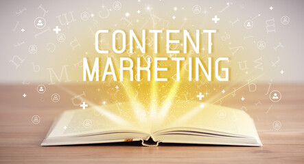 Open book with CONTENT MARKETING inscription, social media concept