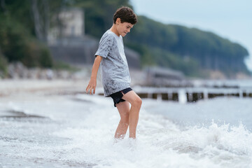 Boy on the beach. Family vacation by the sea. Active lifestyle