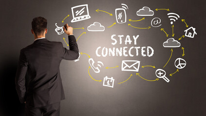 businessman drawing social media icons with STAY CONNECTED inscription, new media concept