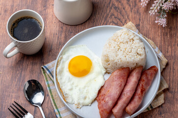 Hamsilog (flatlay)- famous Filipino meal that consists of fried rice, egg and ham slices.