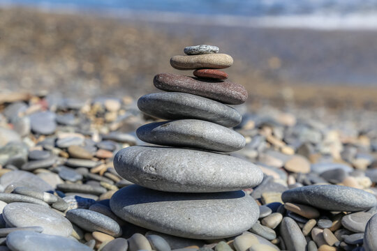 Stacked stones center of focus on a beach