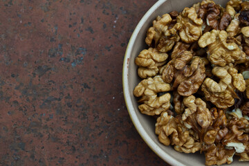 Walnuts harvest on vintage metal background. Walnut kernels. Countryside agriculture. Organic autumn nuts harvest.