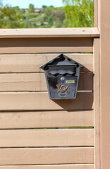 Mailbox on the painted wooden fence of the house in the summer