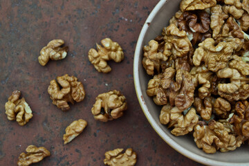 Walnuts harvest on vintage metal background. Walnut kernels. Countryside agriculture. Organic autumn nuts harvest.