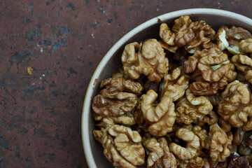 Walnuts harvest on vintage metal background. Walnut kernels. Countryside agriculture. Organic autumn nuts harvest.
