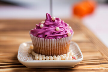 festive cupcake with bright cream and decor, edible pearls,