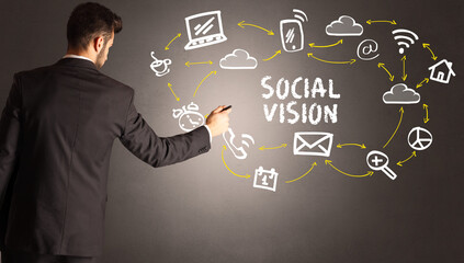 businessman drawing social media icons with SOCIAL VISION inscription, new media concept