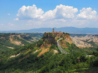 Fototapeta na wymiar Civita di Bagnoregio. Ancient town or hilltop medieval village overlooking to Tiber river valley in province of Viterbo. It is only accessible by walking on long pedestrian bridge from Bagnoregio city
