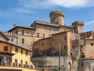 Fototapeta premium Fiano Romano is small, beautiful village in Metropolitan City of Rome, with medieval, colorful houses and ancient Ducal Orsini Castle in the old town. Traditional Italian cityscape in the summer.