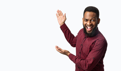 Excited African Man Showing Blank Space Aside Over White Background