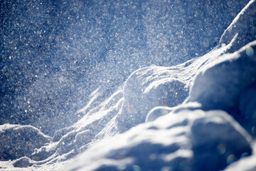 Winter background. Winter bright landscape with snowdrifts and falling snow.