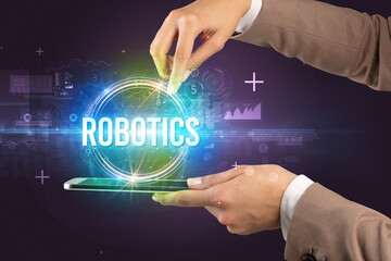 Close-up of a touchscreen with ROBOTICS inscription, new technology concept