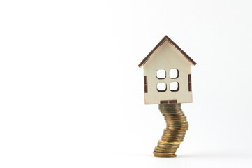 wooden house on coins, the concept of the crisis in housing construction
