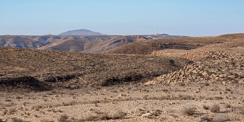 a rugged barren mountainous desert landscape west of the makhtesh ramon crater with an israeli...