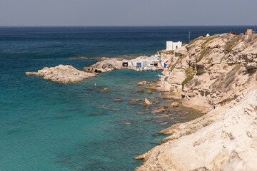 Fototapeta na wymiar small fishing village behind the cliffs on Milos island, Greece
