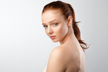 Shirtless Woman With Red Hair And Ponytail Posing, White Background