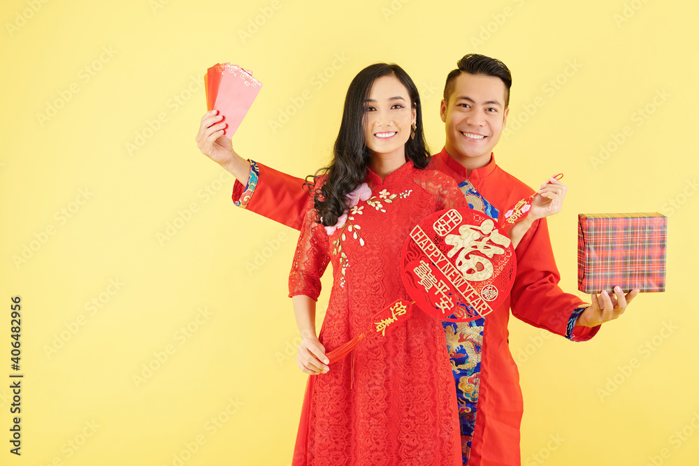 Sticker smiling couple showing chinese new year decorations with happy wishes, lucky money envelopes and a g