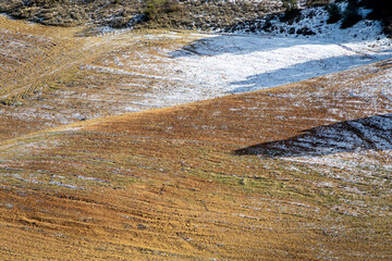 Textured background of a plowed field after a light snowfall in Andalucia