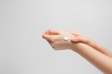 Woman applying hand cream for hands.