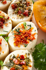 Small cheese appetizers with herbs and dried vegetables