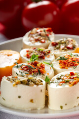 Small cheese appetizers with herbs and dried vegetables