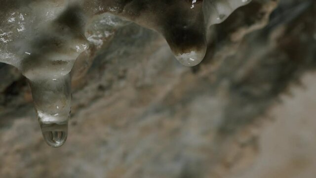 Water drop from a stalactite inside a cave