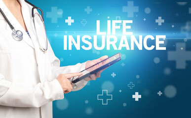 doctor writes notes on the clipboard with LIFE INSURANCE inscription, first aid concept