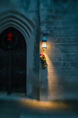 Christmas decorations on church door at night