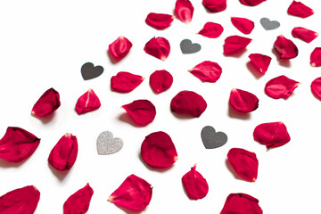 Rose petals and heart-shaped confetti are on a white background.  Floral layout for valentine's day, birthday, wedding invitation. Flat lay. Top view.