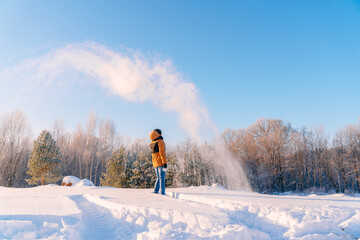 The young man, with a sharp wave of his hand, pours hot water from a cup. The paradoxical "Mpemba effect". Effect of the blast of frosty smoke signal