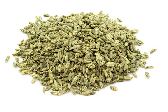 Heap of fennel seeds against white background