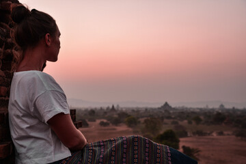 Fototapeta na wymiar young woman looking at sunset in Bagan, Myanmar