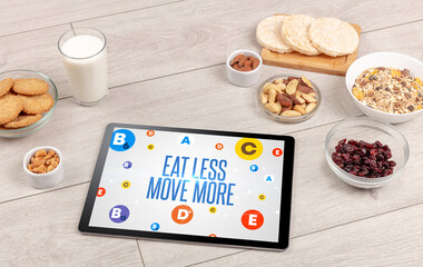 Healthy Tablet Pc compostion with EAT LESS MOVE MORE inscription, weight loss concept