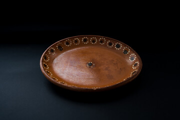 Mexican clay dish on black background
