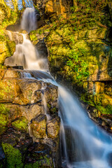 A long exposure view of  an upper waterfall cascade at Lumsdale on Bentley Brook, Derbyshire, UK