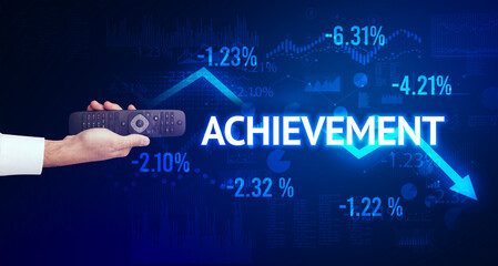 male hand holding wireless peripheral with ACHIEVEMENT inscription, modern business concept